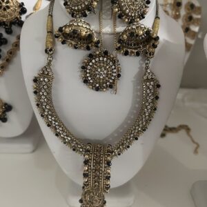 Vintage Charm: Antique Gold Jhumka Set with Black & Clear Stones